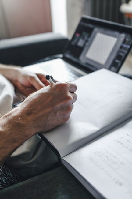 person writing technical document on laptop